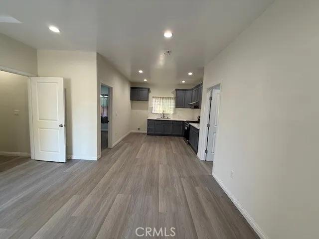 a view of kitchen with wooden floor and electronic appliances