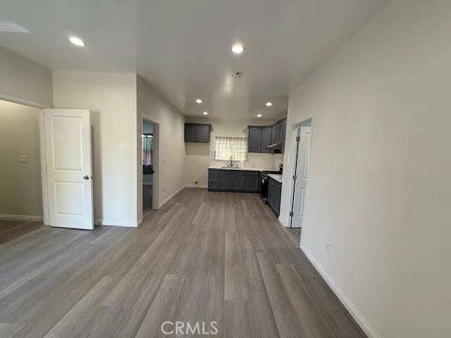 a view of kitchen with wooden floor and electronic appliances