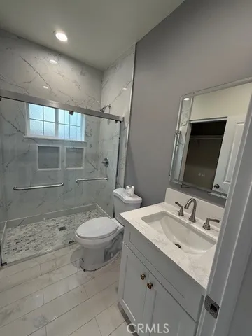 a bathroom with a sink toilet and shower