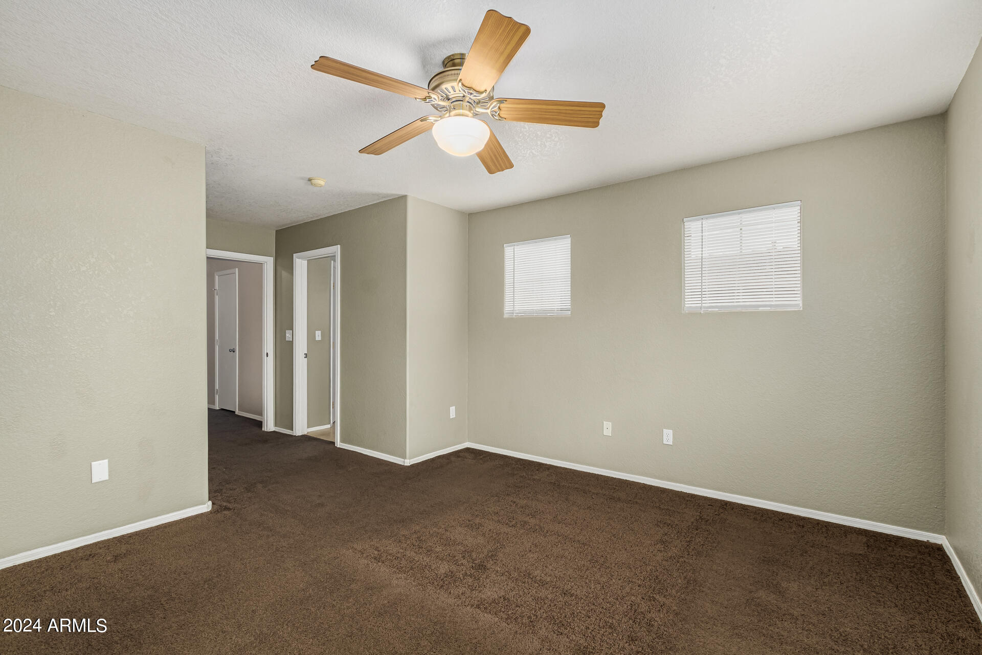 1371 South Boulder Street, Unit A Gilbert, AZ 85296 - Photo 22 of 43 an empty room with a ceiling fan and window