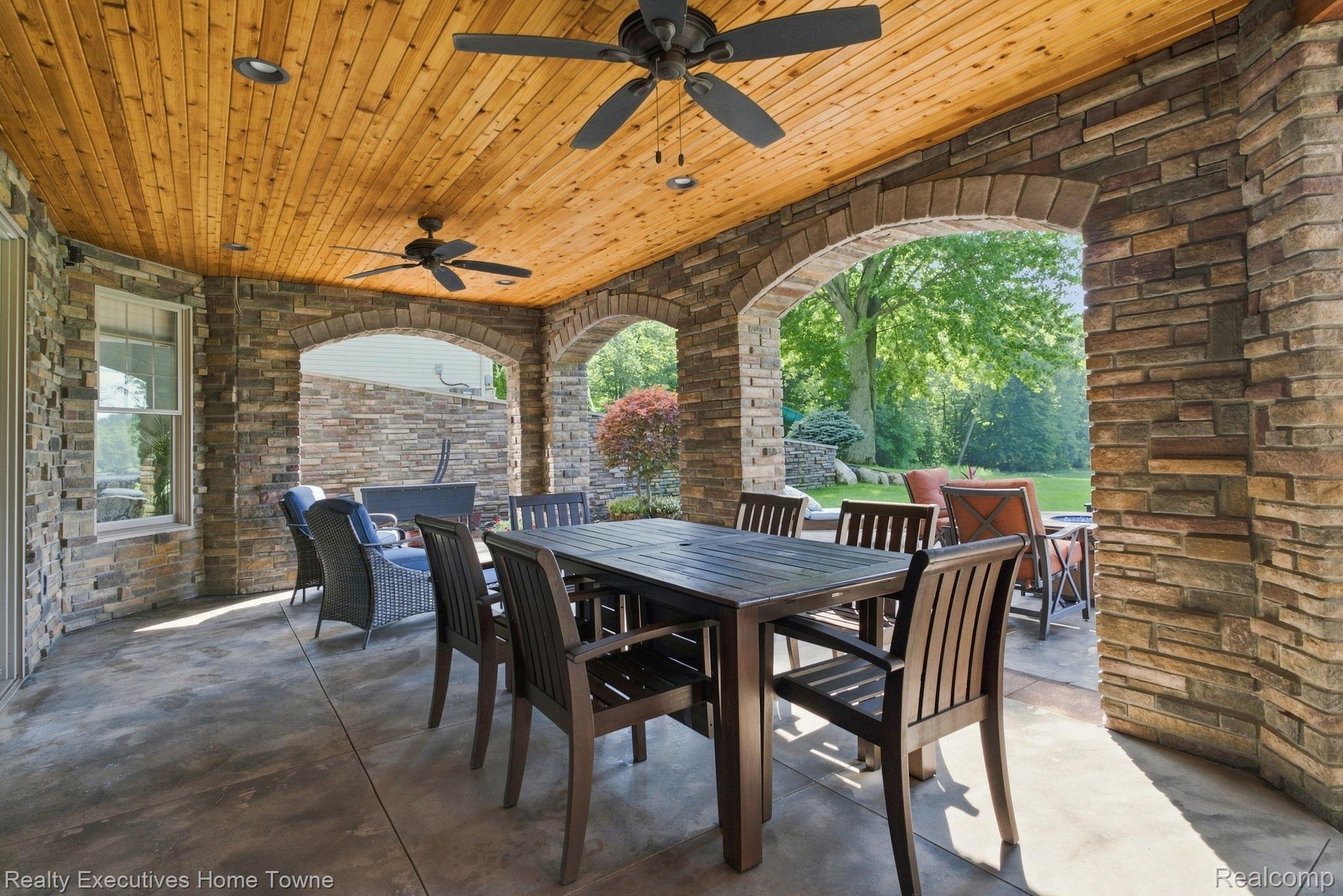 2829 Riverside Drive Port Huron, MI 48060 - Photo 63 of 99 Stone column and arch patio with a wood-plank ceiling, recessed lighting, and ceiling fans