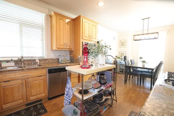 a kitchen with a dining table chairs and white appliances