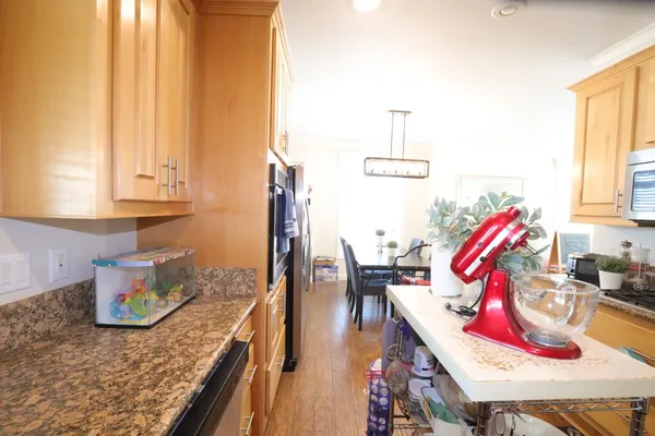 a view of a kitchen with granite countertop a rug stove next to a window