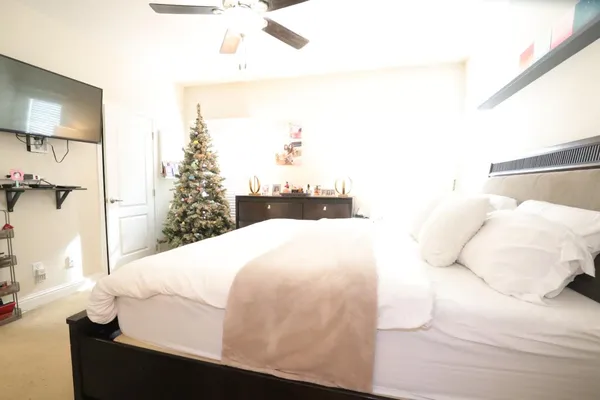 a bedroom with a bed and a mirror