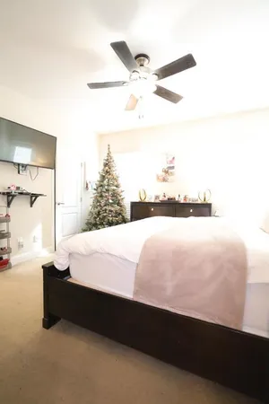 a bed sitting in a bedroom next to a window