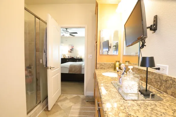a en suite bathroom with a tub sink and mirror