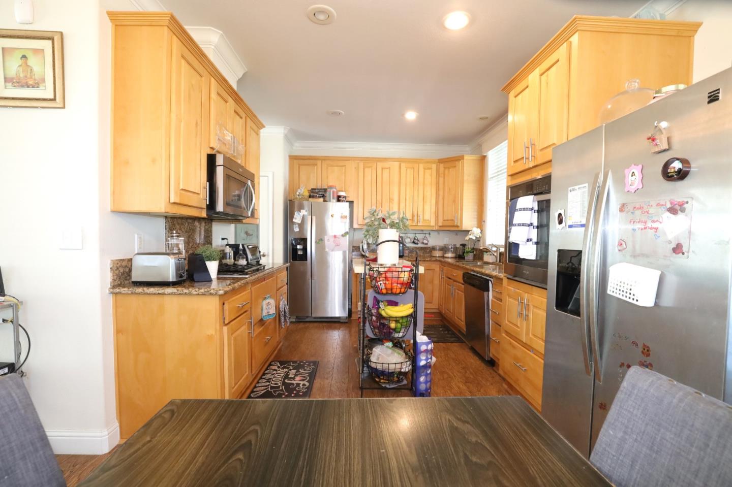 5450 Monterey Road, Unit 182 San Jose, CA 95111 - Photo 10 of 33 a view of a kitchen with kitchen island stainless steel appliances wooden floor and a window