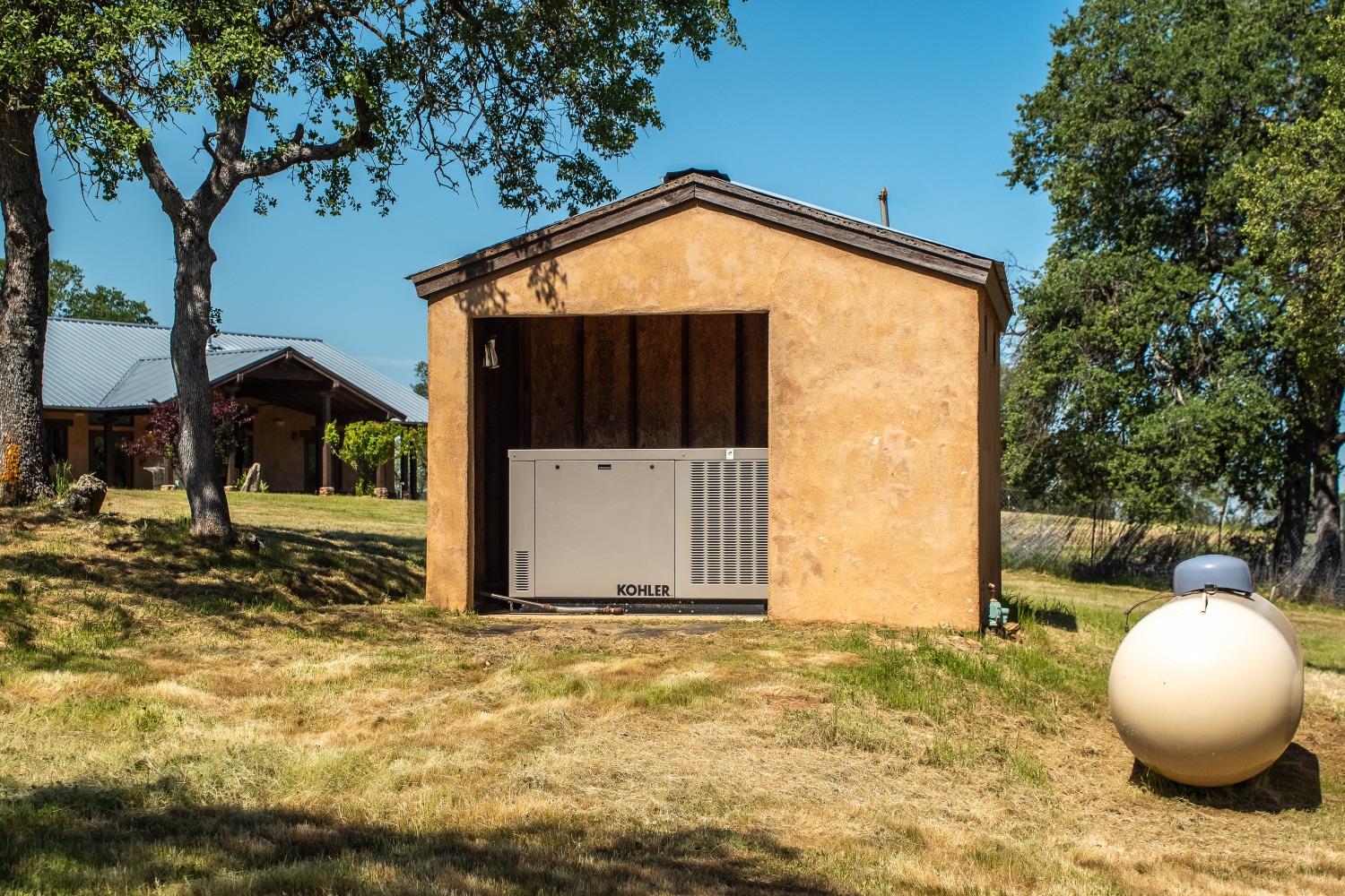 8591 Hogan Dam Road Valley Springs, CA 95252 - Photo 35 of 85 Back-up Generator and Propane tank at main house.
