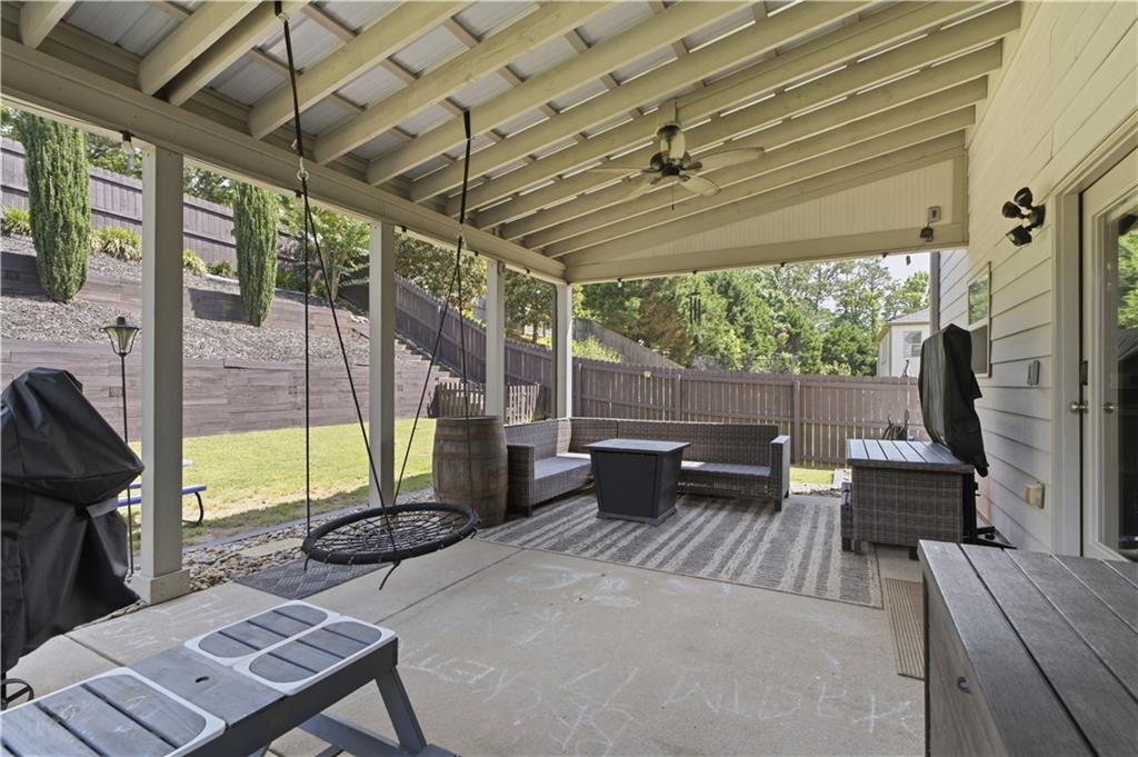 5825 Willow Oak Pass Cumming, GA 30040 - Photo 43 of 55 a view of a patio with a table chairs and a floor to ceiling window
