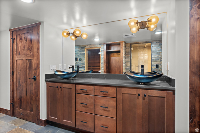 4221 Juniper Circle Alpine, UT 84004 - Photo 37 of 66 Dual vessel sinks with wall-mounted matte black faucets on a dark countertop