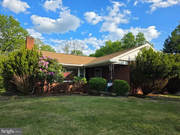 a view of a house with a yard and potted plants