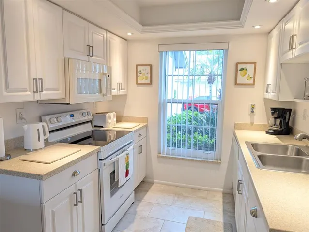 a kitchen that has a sink and a stove in it