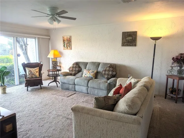 a living room with furniture and a lamp