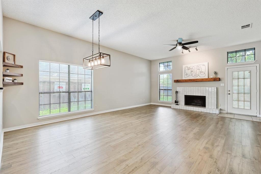 986 Mauve Drive Lewisville, TX 75067 - Photo 1 of 1 a view of empty room with wooden floor and fireplace