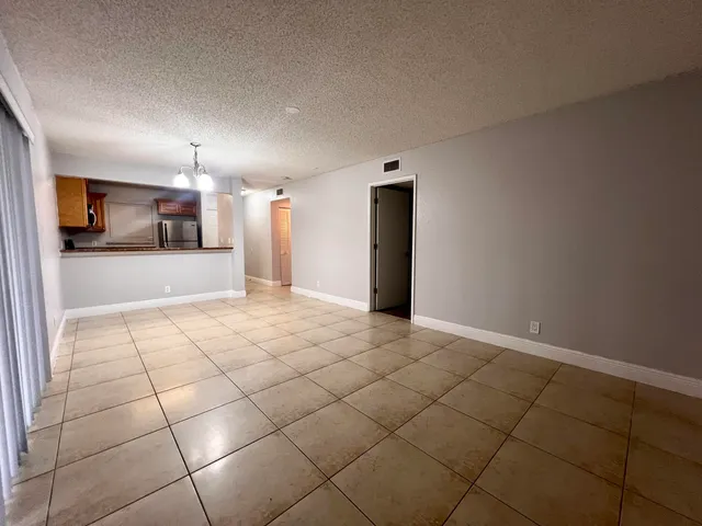 a view of a livingroom with furniture and an empty room