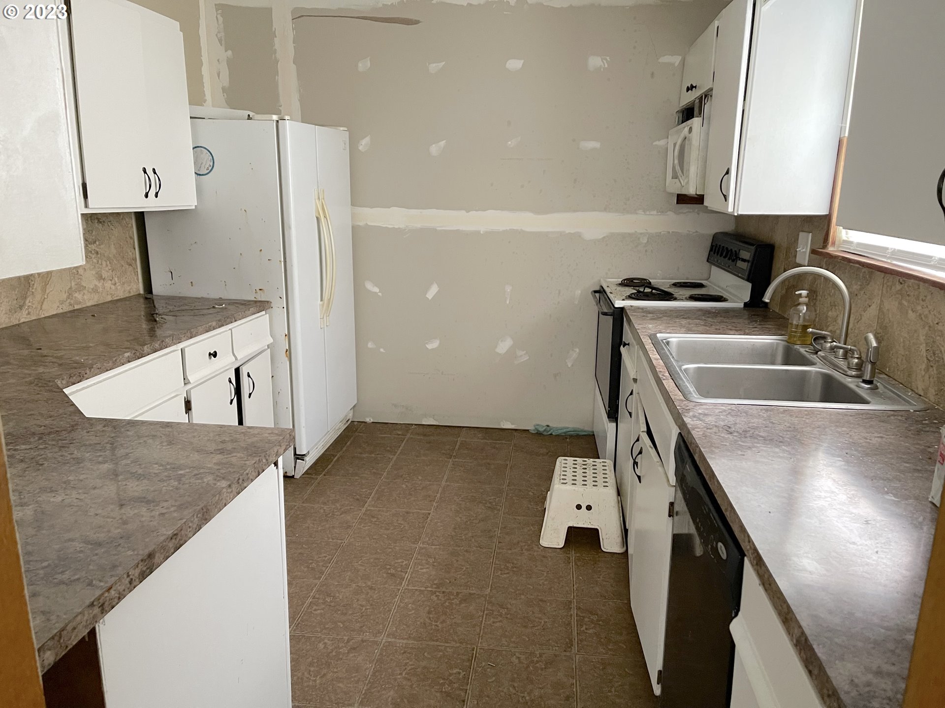 74479 Columbia River Highway Rainier, OR 97048 - Photo 12 of 21 a kitchen with a sink a stove and a refrigerator