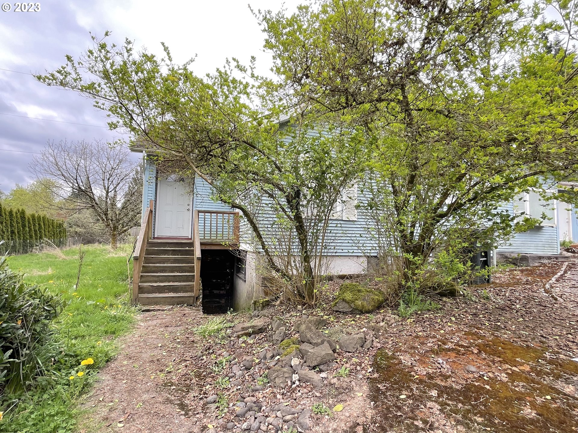 74479 Columbia River Highway Rainier, OR 97048 - Photo 4 of 21 a front view of a house with a garden