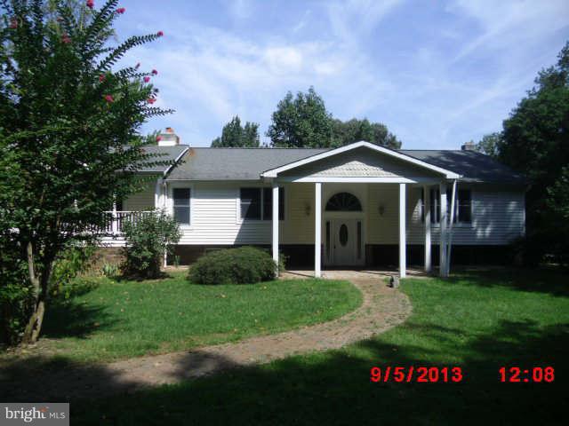 936 Parkey Road Gambrills, MD 21054 - Photo 1 of 2 a front view of a house with a garden