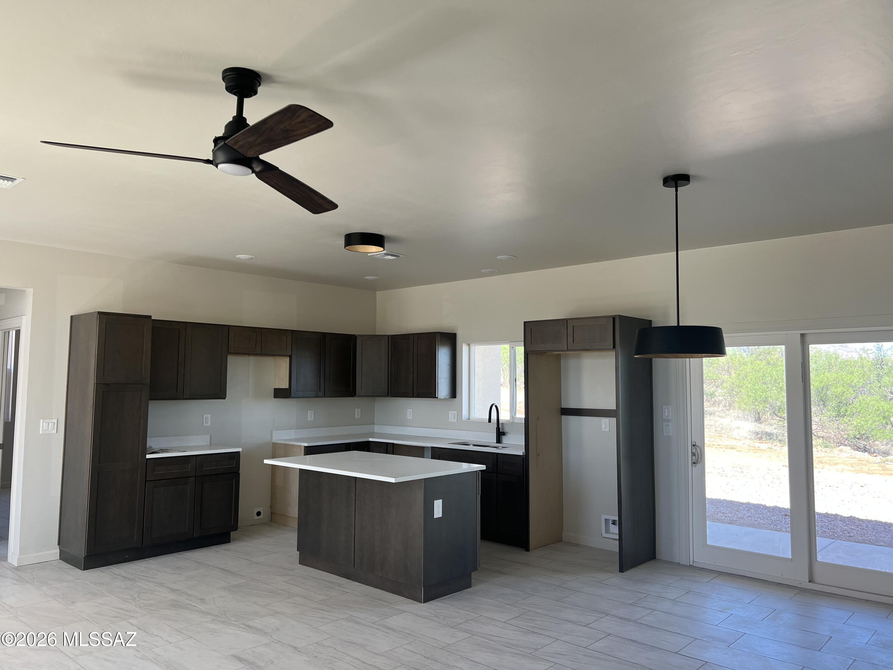 1501 Circulo Sombrero Rio Rico, AZ 85648 - Photo 9 of 26 a large kitchen with a large counter top space and stainless steel appliances