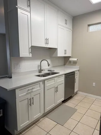 a kitchen with white cabinets