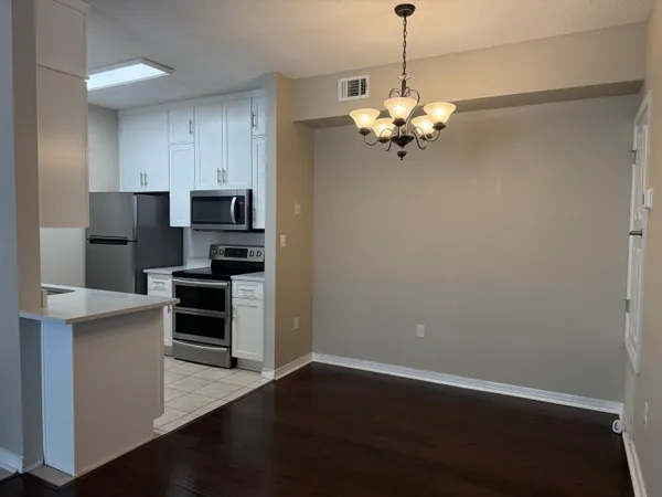 a kitchen with stainless steel appliances a refrigerator and a stove top oven