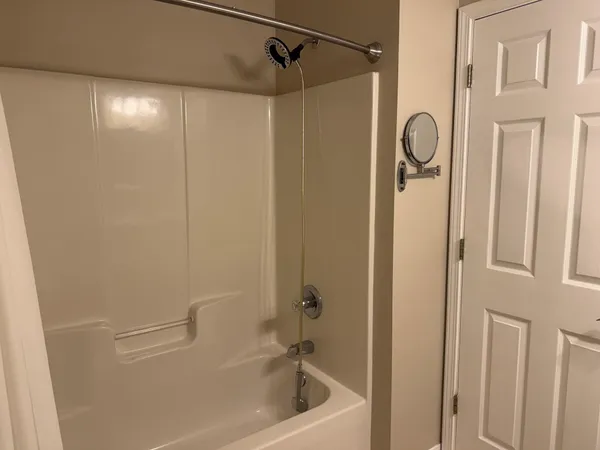 a bathroom with a shower and a bath tub