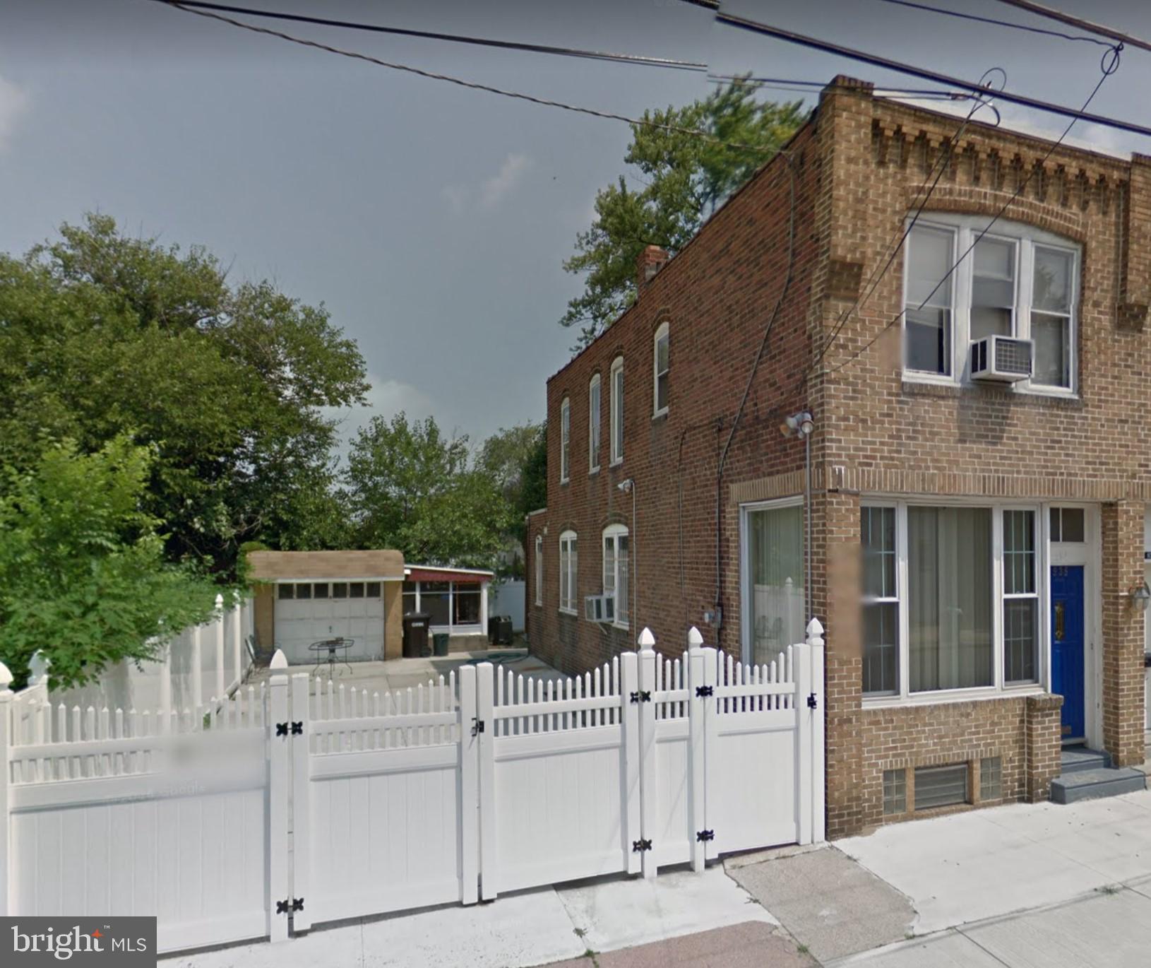935 Howe Street Camden, NJ 08104 - Photo 1 of 14 a front view of white house with a garden
