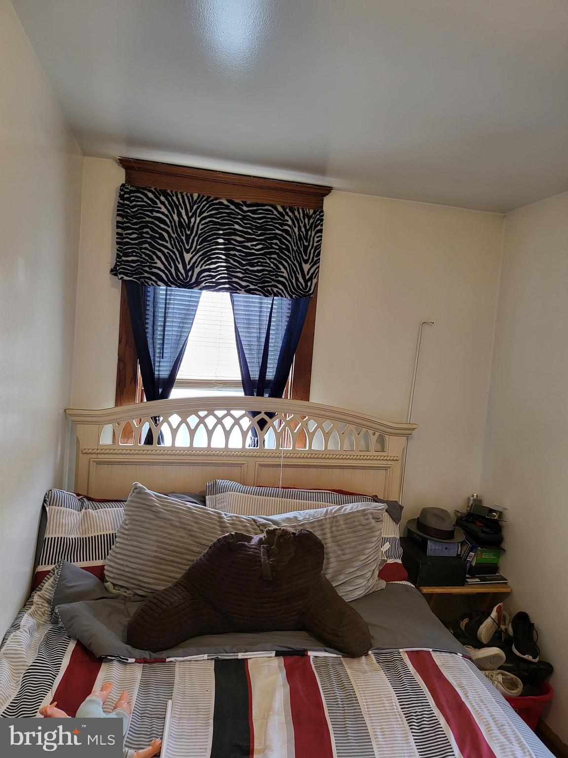 935 Howe Street Camden, NJ 08104 - Photo 7 of 14 a bed sitting in a bedroom next to a lamp