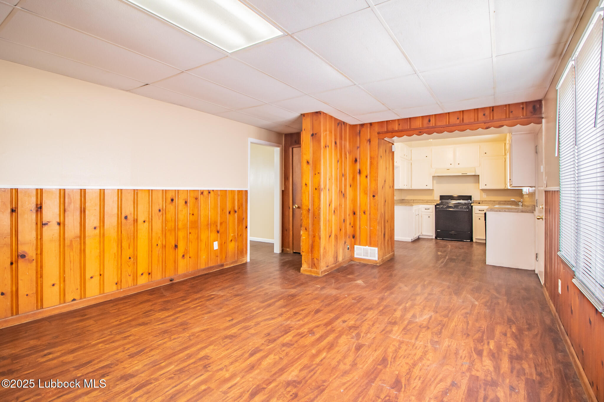 2414 38th Street Lubbock, TX 79412 - Photo 8 of 20 a view of a kitchen with wooden floor and electronic appliances