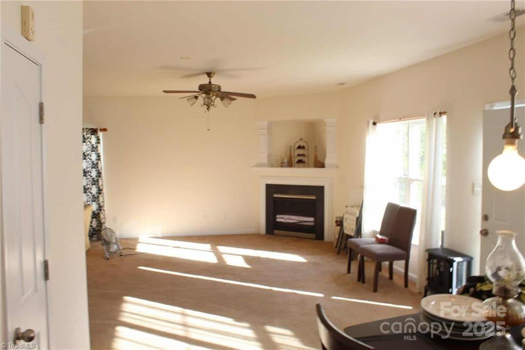 2136 Burton Road High Point, NC 27262 - Photo 2 of 3 a living room with furniture a fireplace and a floor to ceiling window