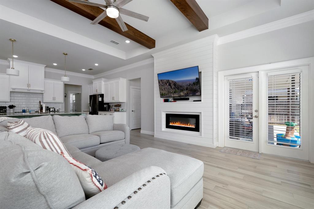 349 Garth Ridge Drive Abilene, TX 79602 - Photo 11 of 33 a living room with furniture a fireplace and a flat screen tv