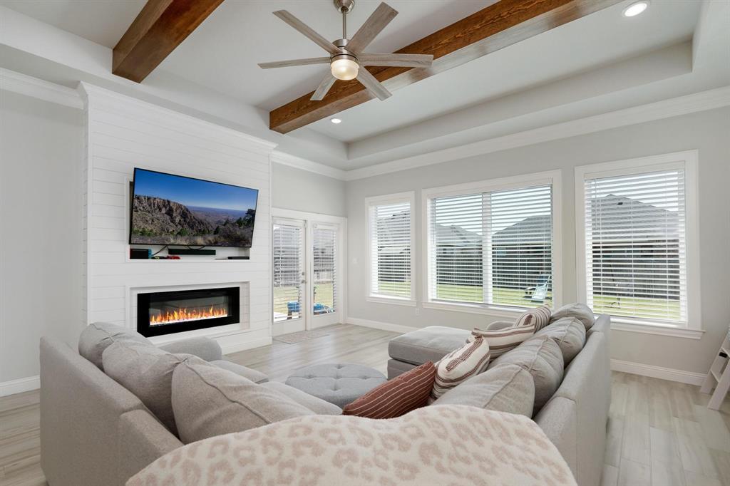 349 Garth Ridge Drive Abilene, TX 79602 - Photo 13 of 33 a living room with furniture flat screen tv a fireplace and a large window