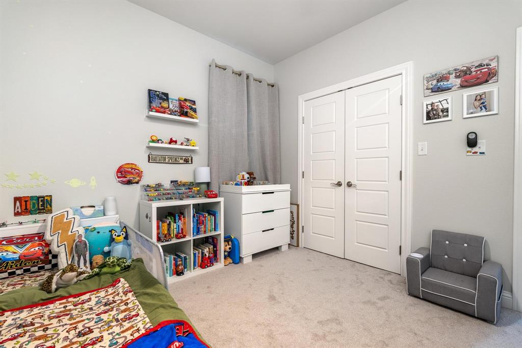 349 Garth Ridge Drive Abilene, TX 79602 - Photo 19 of 33 a bedroom with furniture and a book shelf