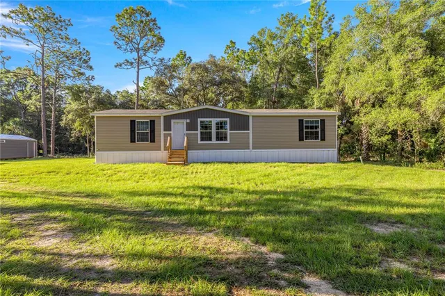 a view of a house with a backyard
