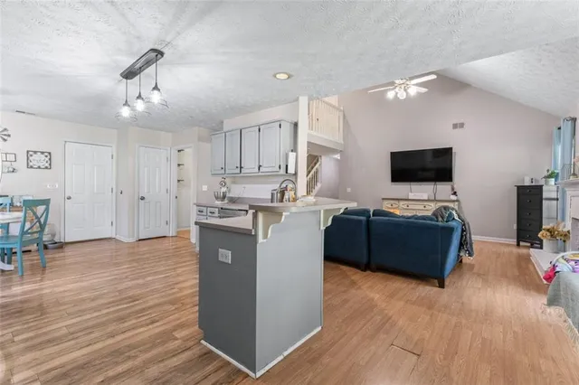 a kitchen with kitchen island a sink cabinets and wooden floor