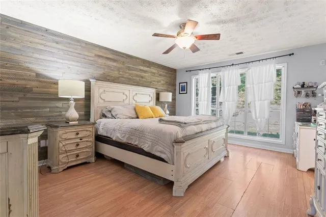 a bedroom with a large bed and a chandelier