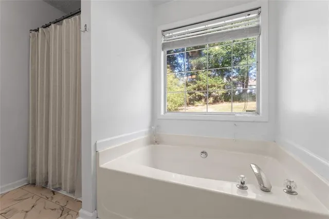 a white bath tub sitting next to a window