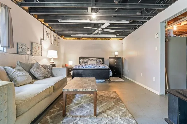 a living room with furniture and a chandelier