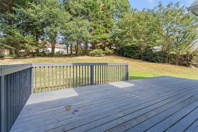 a view of a house with a swimming pool and a yard