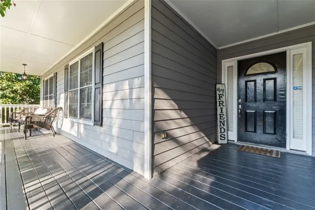 a view of an entryway with wooden floor and door