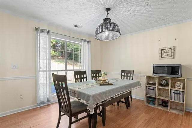 a view of a dining room with furniture window and wooden floor