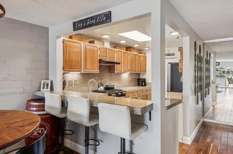 a kitchen with stainless steel appliances a stove a refrigerator and cabinets