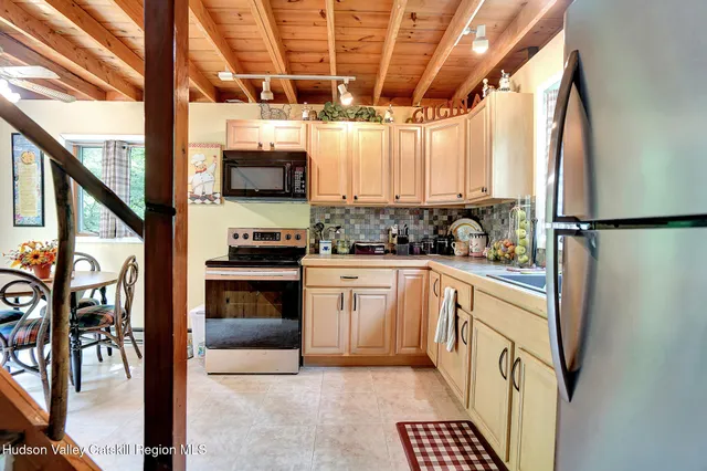 a kitchen with a refrigerator and a stove