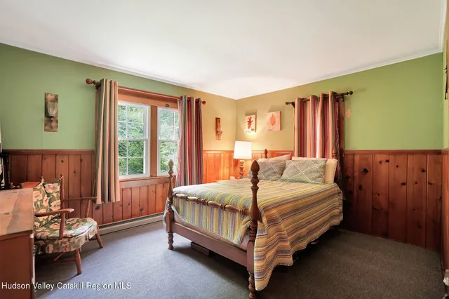 a bedroom with a bed chair and window