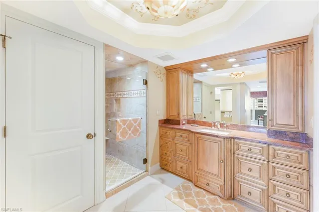 a spacious bathroom with a shower a sink and a mirror