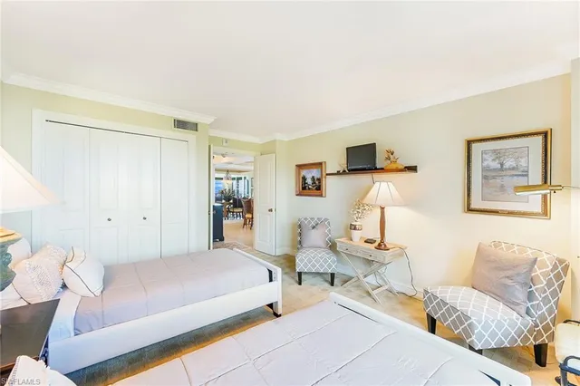 a spacious bedroom with a bed and a couch