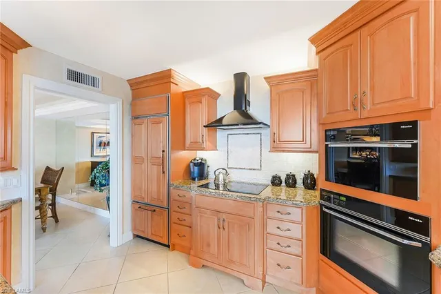 a kitchen with stainless steel appliances granite countertop a sink and cabinets