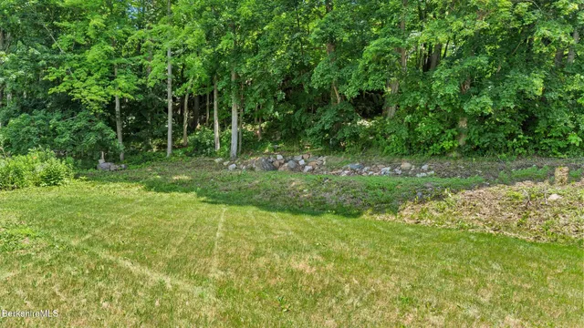 a view of a room with furniture and wooden floor