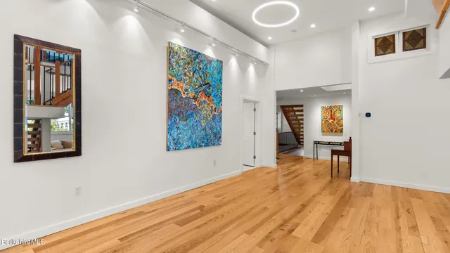 a balcony with wooden floor stairs and furniture