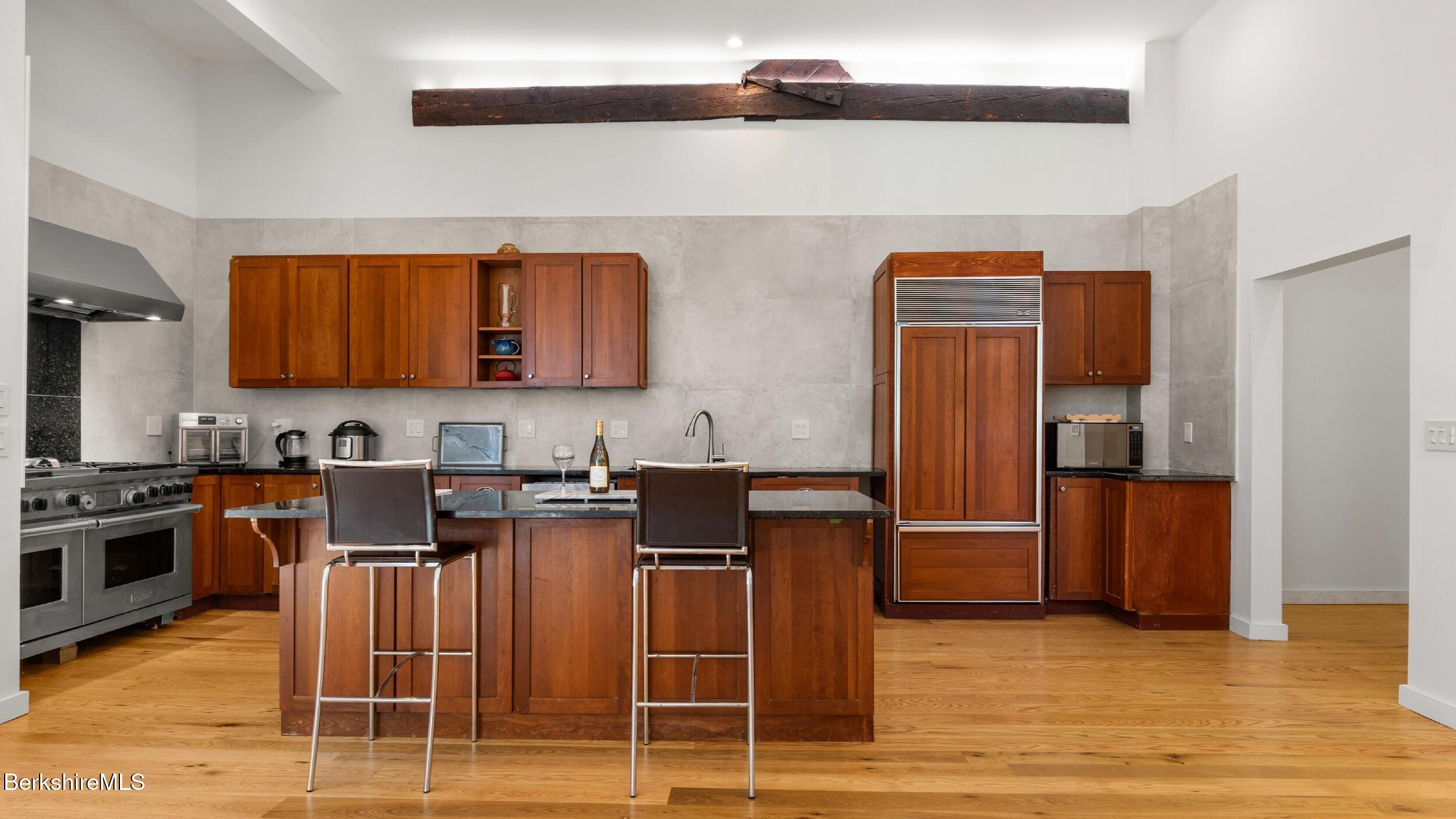 160 High Street Lee, MA 01238 - Photo 23 of 68 a kitchen with granite countertop a refrigerator stove top oven and sink
